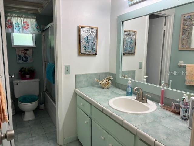 8411 N Pine Needle Ter, Crystal River, FL 34428 - bathroom featuring vanity, tile patterned flooring, and bath / shower combo with glass door