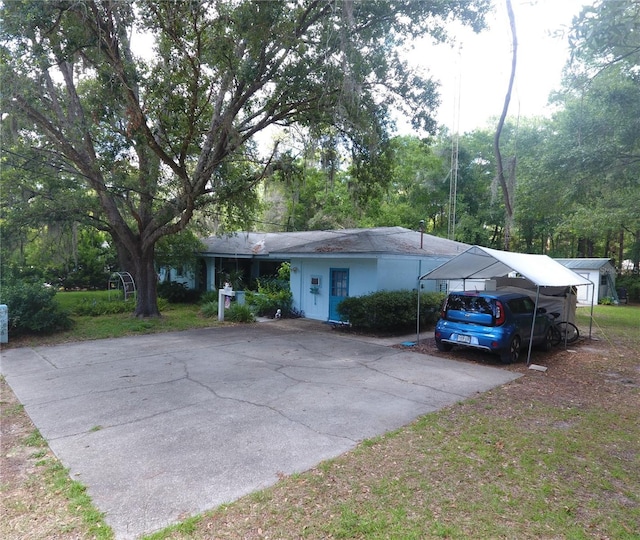 8411 N Pine Needle Ter, Crystal River, FL 34428 - ranch-style house with asphalt driveway and a carport