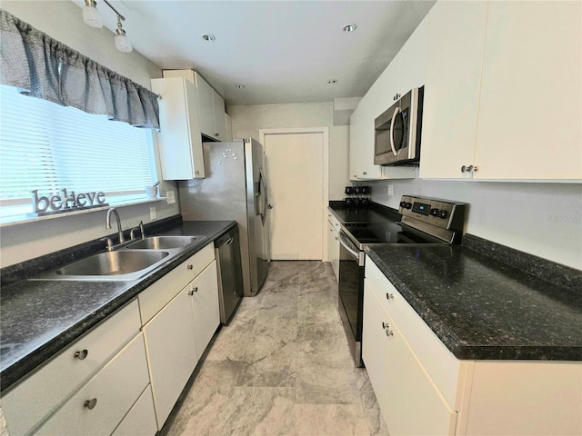 4110 NW 44th Dr Unit 0, Gainesville, FL 32606 - kitchen featuring appliances with stainless steel finishes, white cabinetry, and dark countertops