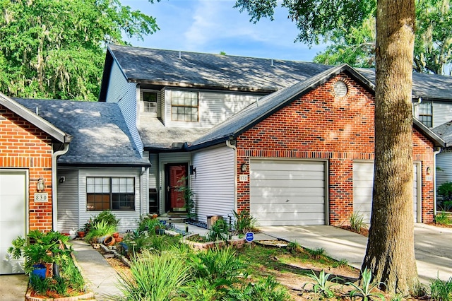 832 NW 42nd Ter, Gainesville, FL 32605 - view of front of home featuring a garage, driveway, a shingled roof, and brick siding