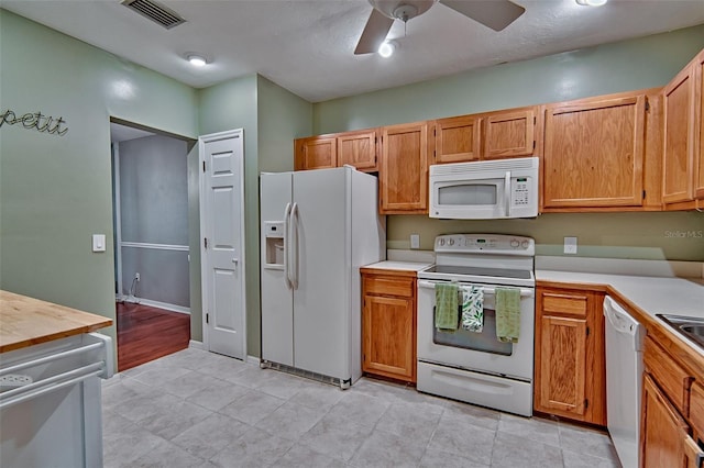 832 NW 42nd Ter, Gainesville, FL 32605 - kitchen with white appliances, light countertops, a ceiling fan, and light tile patterned flooring