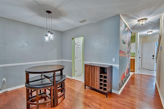 832 NW 42nd Ter, Gainesville, FL 32605 - dining room featuring light wood-style flooring and baseboards