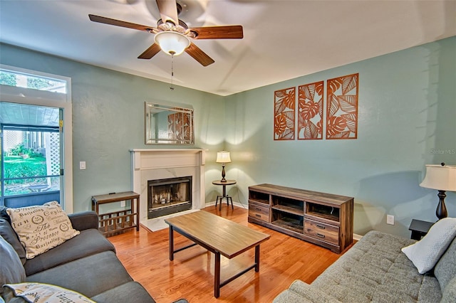 832 NW 42nd Ter, Gainesville, FL 32605 - living room with ceiling fan, wood finished floors, and a fireplace