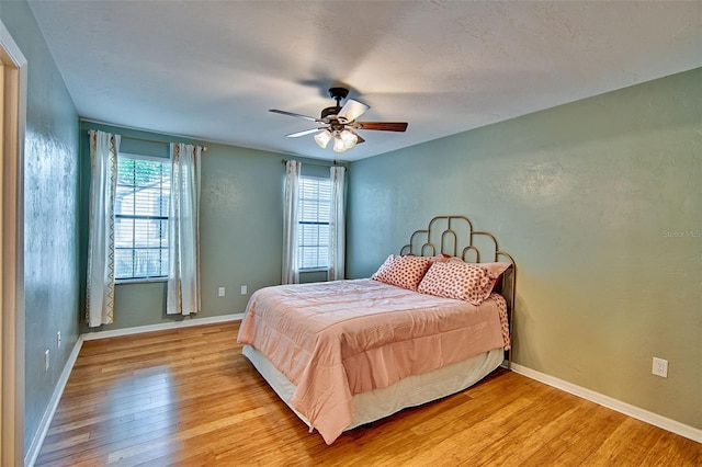 832 NW 42nd Ter, Gainesville, FL 32605 - bedroom with light wood-style flooring and ceiling fan
