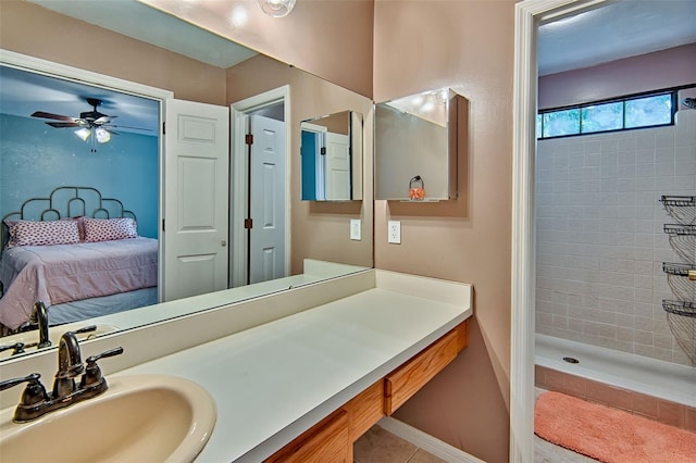 832 NW 42nd Ter, Gainesville, FL 32605 - bathroom with tiled shower, connected bathroom, vanity, tile patterned floors, and ceiling fan