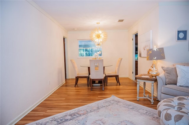 9835 NW 6th Pl, Gainesville, FL 32607 - dining space featuring light wood finished floors, a chandelier, and ornamental molding