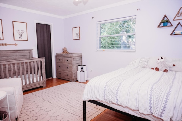 9835 NW 6th Pl, Gainesville, FL 32607 - bedroom featuring wood finished floors and ornamental molding