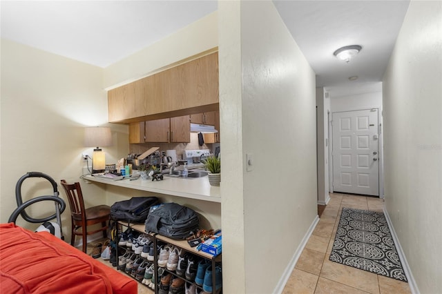 2635 SW 35th Pl Unit 304, Gainesville, FL 32608 - hallway with light tile patterned floors and baseboards