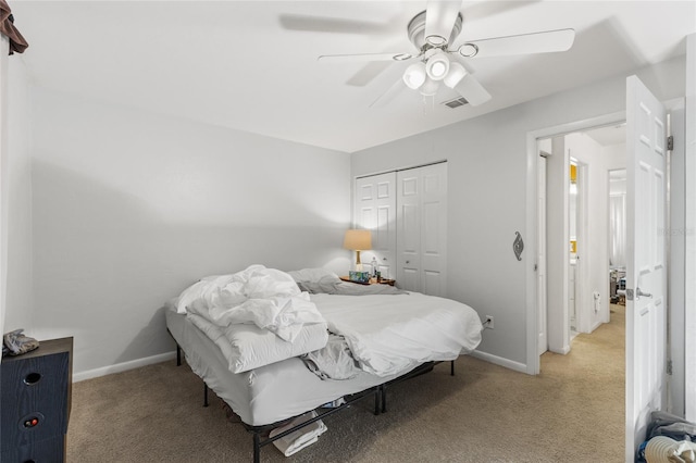 2635 SW 35th Pl Unit 304, Gainesville, FL 32608 - bedroom featuring light colored carpet, a closet, and a ceiling fan