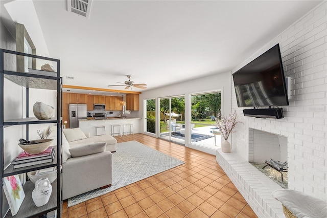 2223 NW 21st Ave, Gainesville, FL 32605 - living room featuring light tile patterned floors, a brick fireplace, and a ceiling fan