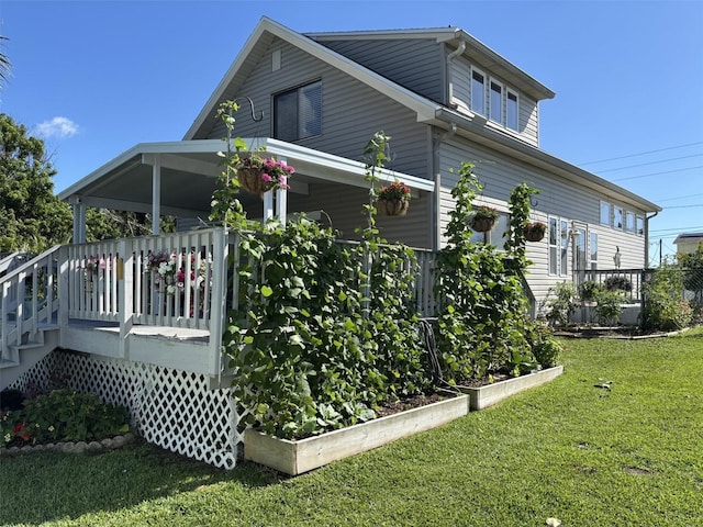 1536 S Central Ave, Flagler Beach, FL 32136 - view of home's exterior featuring a yard, a vegetable garden, and a deck