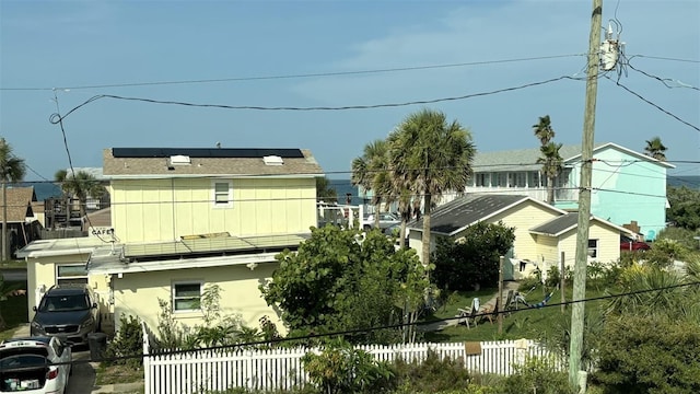 1536 S Central Ave, Flagler Beach, FL 32136 - back of house with roof mounted solar panels and stucco siding