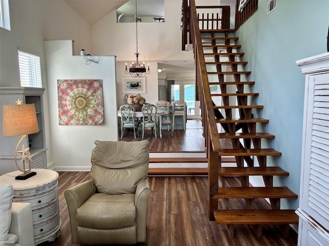 1536 S Central Ave, Flagler Beach, FL 32136 - living area featuring wood finished floors, stairway, healthy amount of natural light, high vaulted ceiling, and a chandelier