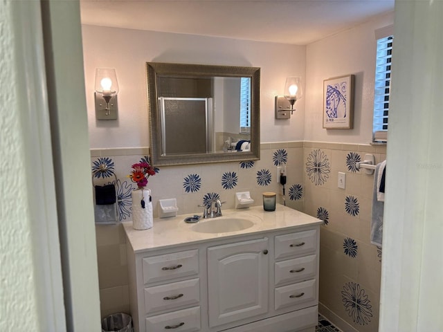 1536 S Central Ave, Flagler Beach, FL 32136 - full bathroom featuring vanity, a stall shower, tile walls, and a wainscoted wall