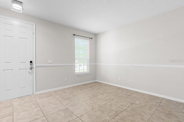 1011 Wetland Ridge Cir, Middleburg, FL 32068 - unfurnished room featuring light tile patterned floors and a textured ceiling
