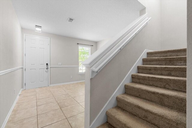 1011 Wetland Ridge Cir, Middleburg, FL 32068 - stairs with tile patterned floors and baseboards