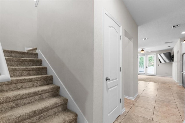 1011 Wetland Ridge Cir, Middleburg, FL 32068 - stairs with tile patterned flooring, french doors, and a ceiling fan
