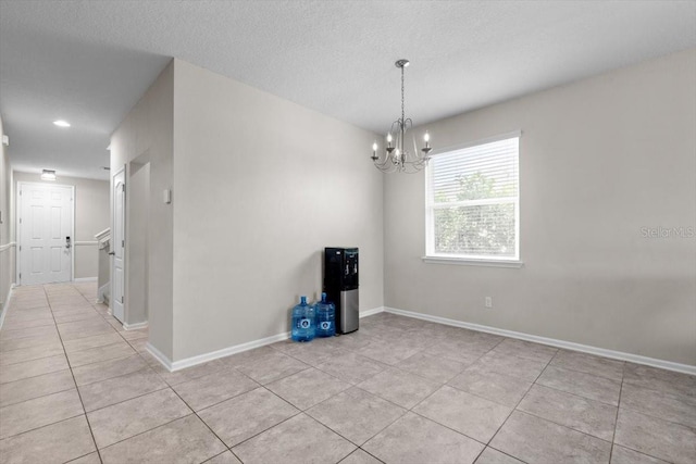 1011 Wetland Ridge Cir, Middleburg, FL 32068 - unfurnished room with light tile patterned floors, a chandelier, and a textured ceiling