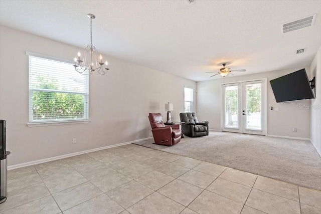 1011 Wetland Ridge Cir, Middleburg, FL 32068 - living area with light carpet, light tile patterned flooring, a chandelier, french doors, and a ceiling fan