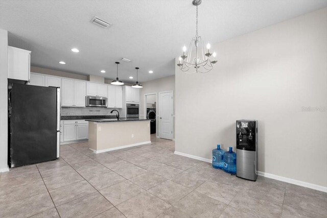 1011 Wetland Ridge Cir, Middleburg, FL 32068 - kitchen featuring appliances with stainless steel finishes, dark countertops, a chandelier, white cabinetry, and recessed lighting