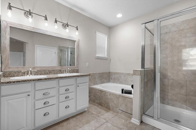1011 Wetland Ridge Cir, Middleburg, FL 32068 - bathroom featuring a stall shower, a bath, tile patterned floors, and double vanity