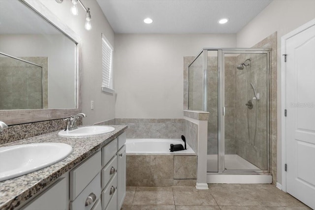 1011 Wetland Ridge Cir, Middleburg, FL 32068 - bathroom featuring a shower stall, a bath, double vanity, tile patterned flooring, and recessed lighting