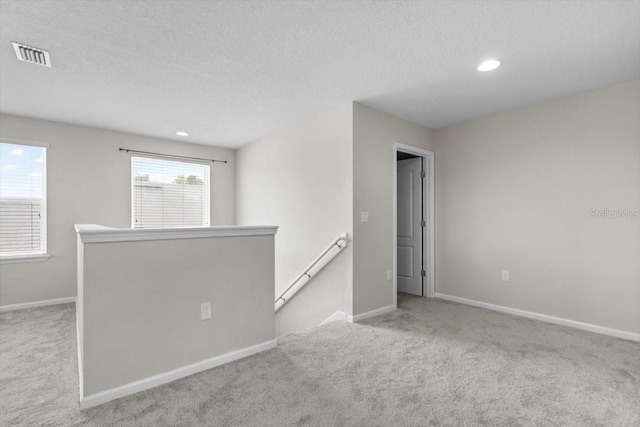 1011 Wetland Ridge Cir, Middleburg, FL 32068 - spare room featuring carpet, a textured ceiling, and recessed lighting
