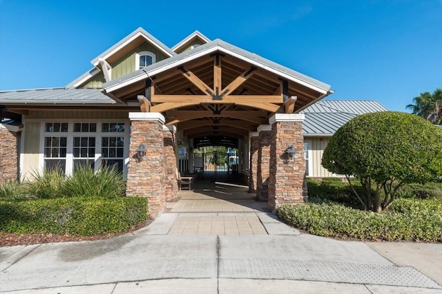 1011 Wetland Ridge Cir, Middleburg, FL 32068 - doorway to property featuring a standing seam roof, a metal roof, stone siding, and board and batten siding