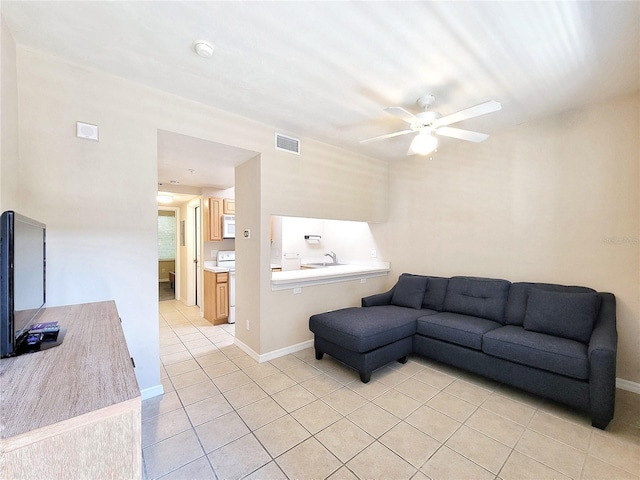 1220 SW 1st Ave Unit 304, Gainesville, FL 32601 - living room featuring light tile patterned floors and a ceiling fan