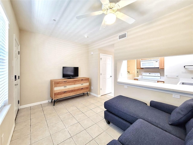 1220 SW 1st Ave Unit 304, Gainesville, FL 32601 - living area featuring light tile patterned floors and a ceiling fan