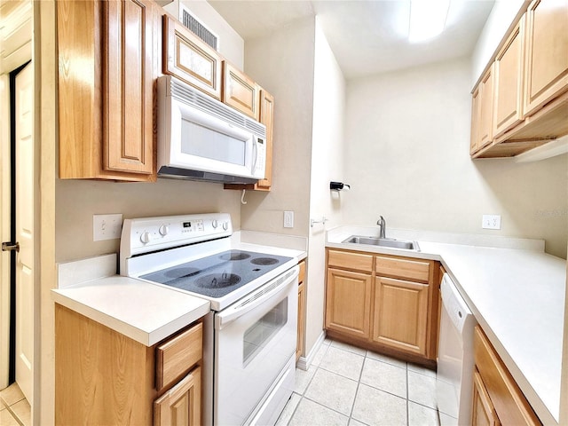 1220 SW 1st Ave Unit 304, Gainesville, FL 32601 - kitchen featuring white appliances, light tile patterned floors, light countertops, and light brown cabinets