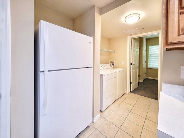1220 SW 1st Ave Unit 304, Gainesville, FL 32601 - laundry area featuring washer and clothes dryer, light tile patterned floors, and light colored carpet
