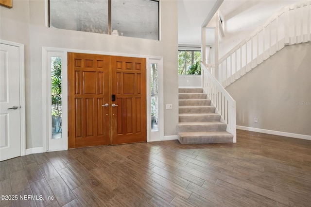 110 Cypress St, Hawthorne, FL 32640 - foyer featuring wood finished floors, stairway, and a towering ceiling
