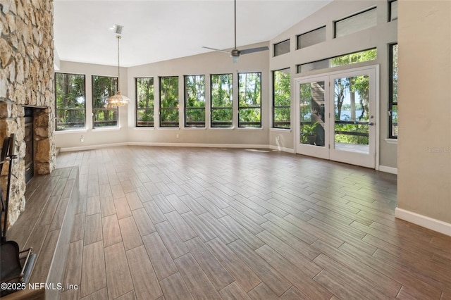 110 Cypress St, Hawthorne, FL 32640 - unfurnished living room featuring wood finished floors, a fireplace, plenty of natural light, ceiling fan, and lofted ceiling