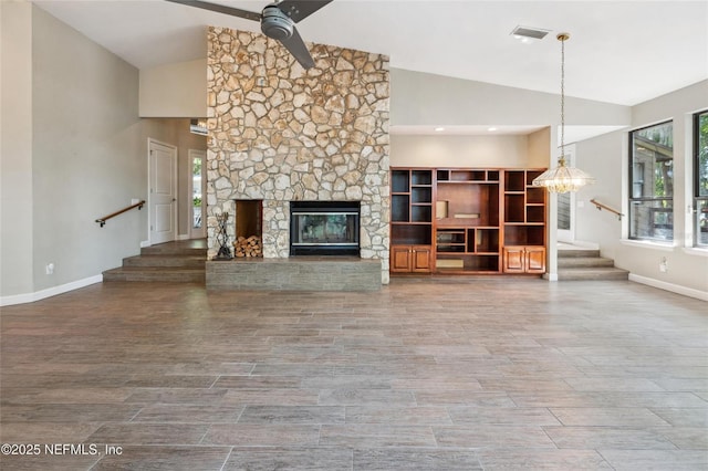 110 Cypress St, Hawthorne, FL 32640 - unfurnished living room featuring stairs, high vaulted ceiling, a ceiling fan, a stone fireplace, and wood finished floors