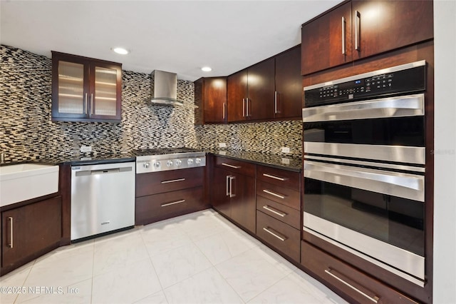 110 Cypress St, Hawthorne, FL 32640 - kitchen featuring appliances with stainless steel finishes, dark countertops, wall chimney exhaust hood, decorative backsplash, and recessed lighting