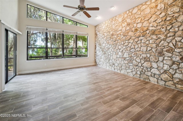 110 Cypress St, Hawthorne, FL 32640 - unfurnished room with lofted ceiling, a ceiling fan, and wood finished floors