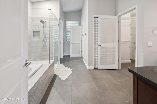 110 Cypress St, Hawthorne, FL 32640 - full bath with a stall shower, vanity, a walk in closet, a bath, and tile patterned flooring