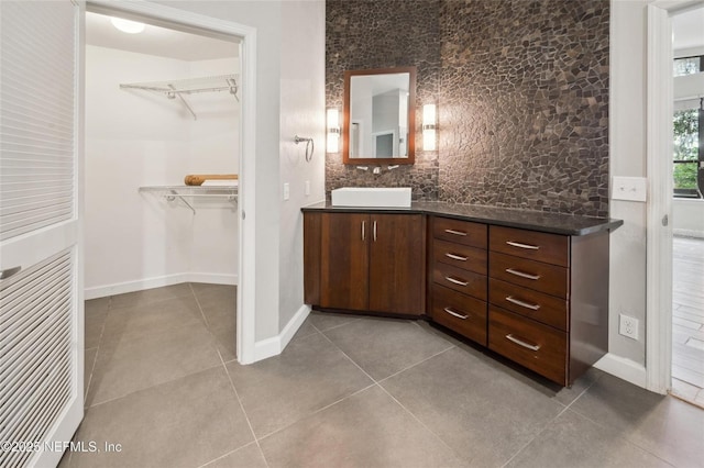 110 Cypress St, Hawthorne, FL 32640 - bathroom featuring vanity, a walk in closet, tile patterned floors, and decorative backsplash