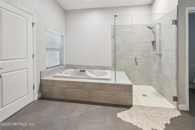 110 Cypress St, Hawthorne, FL 32640 - full bathroom with a garden tub, a shower stall, and tile patterned flooring