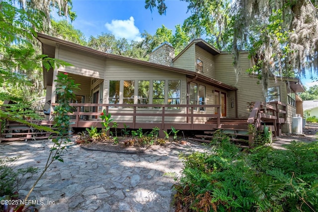 110 Cypress St, Hawthorne, FL 32640 - back of property featuring a patio, a wooden deck, and a chimney