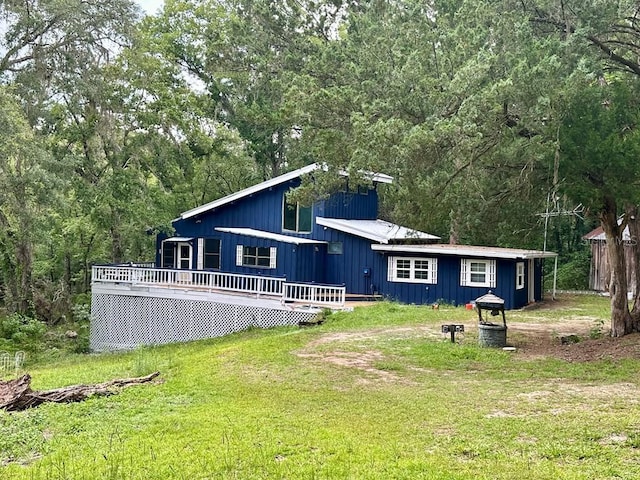 9947 SW 37th St, Lake Butler, FL 32054 - back of property with a deck, a yard, and a wooded view