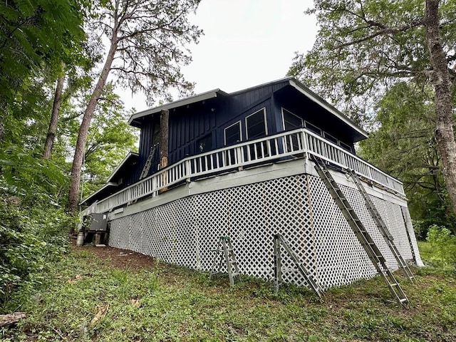 9947 SW 37th St, Lake Butler, FL 32054 - view of home's exterior featuring board and batten siding and a deck