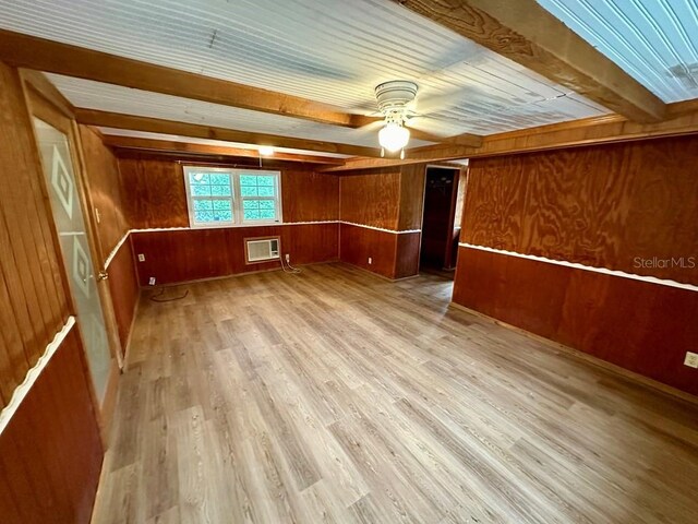 9947 SW 37th St, Lake Butler, FL 32054 - spare room featuring ceiling fan, wooden walls, light wood-style flooring, a wooden ceiling with exposed beams, and an AC wall unit