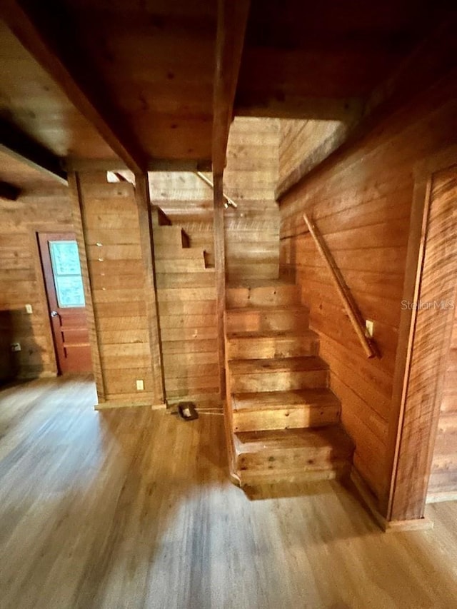 9947 SW 37th St, Lake Butler, FL 32054 - staircase with wood walls, wood finished floors, and beam ceiling
