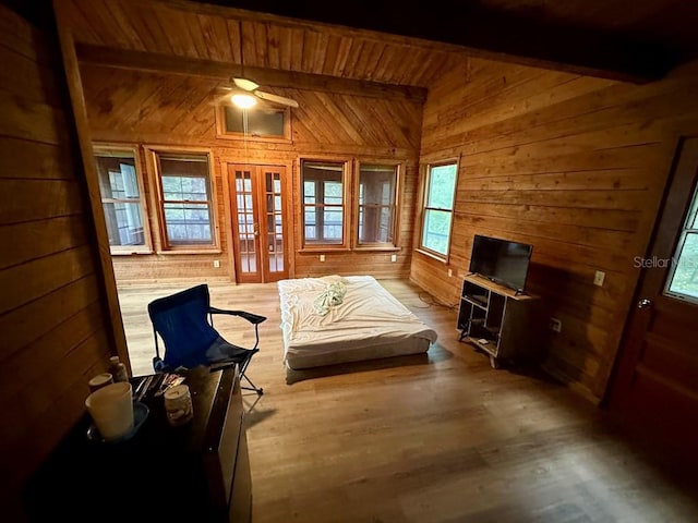 9947 SW 37th St, Lake Butler, FL 32054 - sitting room with wooden walls, a wood ceiling with exposed beams, wood finished floors, french doors, and ceiling fan