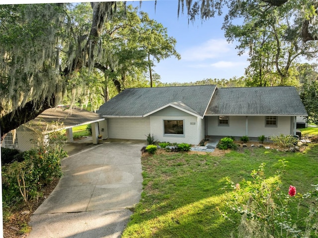 900 NW Snug Harbor Rd, Crystal River, FL 34428 - single story home with driveway, a carport, a front lawn, and roof with shingles