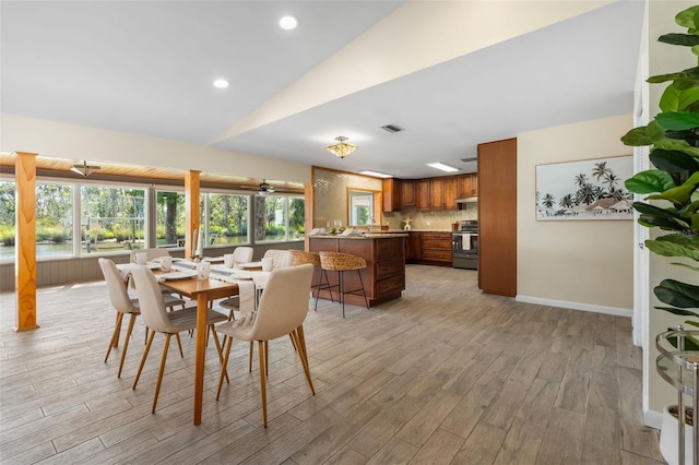 900 NW Snug Harbor Rd, Crystal River, FL 34428 - dining room with light wood finished floors, vaulted ceiling, and recessed lighting