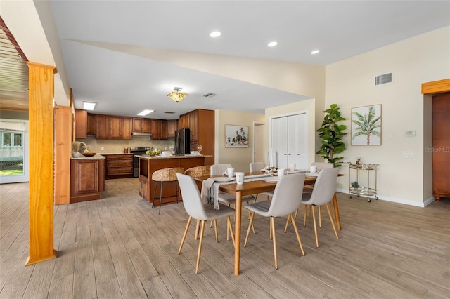 900 NW Snug Harbor Rd, Crystal River, FL 34428 - dining space with light wood finished floors, high vaulted ceiling, and recessed lighting