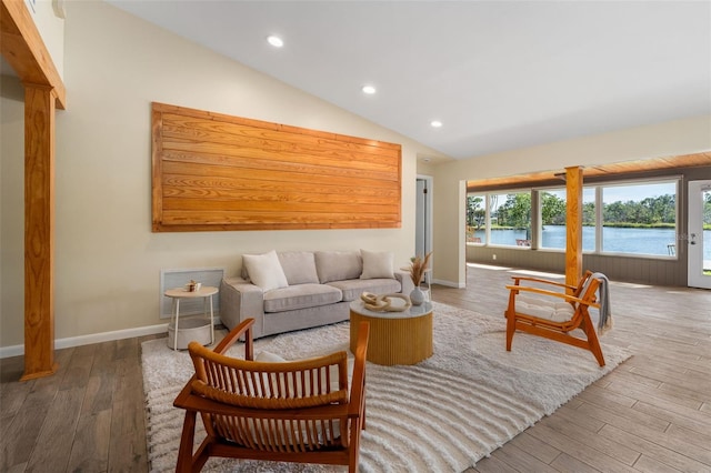 900 NW Snug Harbor Rd, Crystal River, FL 34428 - living area with wood finished floors, lofted ceiling, recessed lighting, and a water view